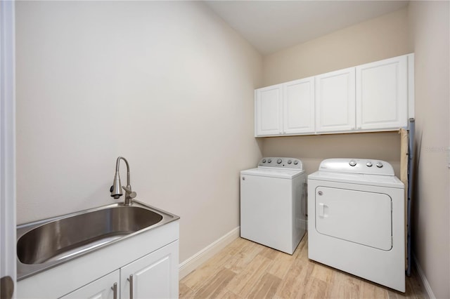 11680 Tapestry Ln, Venice, FL 34292 - washroom with cabinet space, independent washer and dryer, and light wood-style flooring