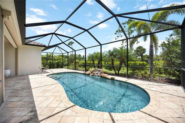 11680 Tapestry Ln, Venice, FL 34292 - outdoor pool with a patio and glass enclosure