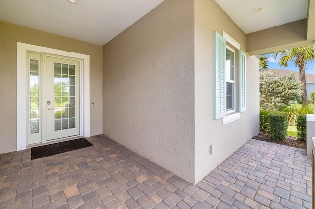 13789 Old Creek Ct, Parrish, FL 34219 - property entrance featuring stucco siding and a patio area