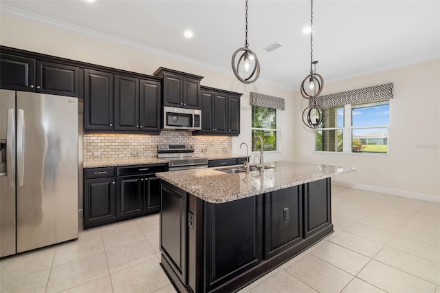 13789 Old Creek Ct, Parrish, FL 34219 - kitchen with stainless steel appliances, dark cabinets, light tile patterned flooring, an island with sink, and ornamental molding