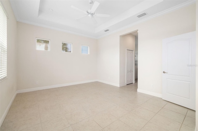 13789 Old Creek Ct, Parrish, FL 34219 - spare room featuring a tray ceiling, ornamental molding, light tile patterned floors, and a ceiling fan