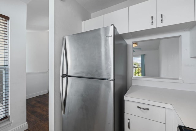 970 Sandpiper Cir Unit 970, Bradenton, FL 34209 - kitchen with freestanding refrigerator, light countertops, white cabinets, and wood finished floors