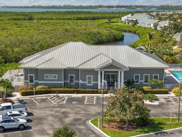 970 Sandpiper Cir Unit 970, Bradenton, FL 34209 - view of building exterior with uncovered parking and a water view