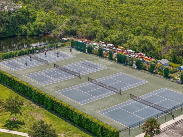 970 Sandpiper Cir Unit 970, Bradenton, FL 34209 - view of tennis court featuring a wooded view and a water view