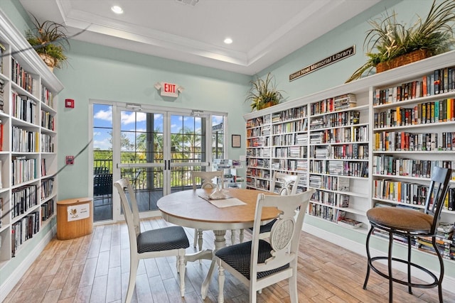970 Sandpiper Cir Unit 970, Bradenton, FL 34209 - dining space with wood finished floors, a tray ceiling, recessed lighting, a towering ceiling, and crown molding