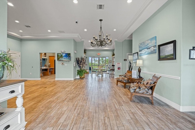 970 Sandpiper Cir Unit 970, Bradenton, FL 34209 - living area with a chandelier, ornamental molding, light wood finished floors, and recessed lighting