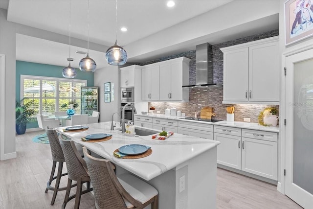 3605 Wild Blossom Pl, Parrish, FL 34219 - kitchen featuring wall chimney range hood, stainless steel appliances, backsplash, a breakfast bar area, and recessed lighting