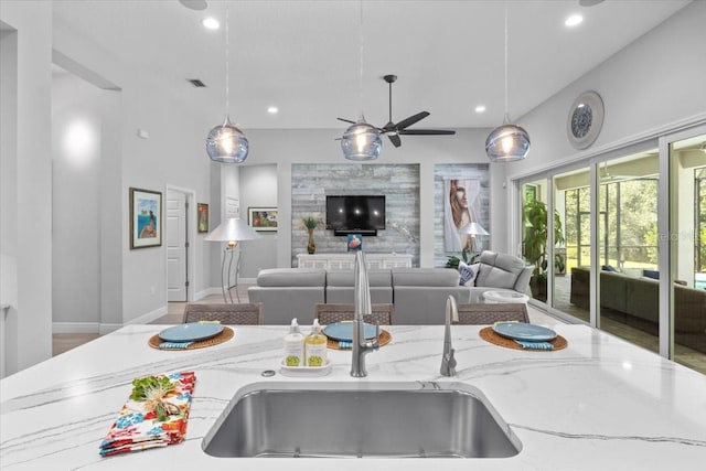 3605 Wild Blossom Pl, Parrish, FL 34219 - kitchen featuring light stone counters, ceiling fan, pendant lighting, recessed lighting, and open floor plan