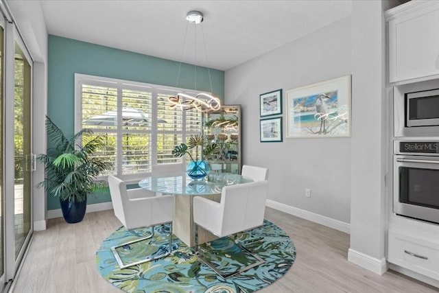 3605 Wild Blossom Pl, Parrish, FL 34219 - dining area featuring a chandelier and light wood finished floors