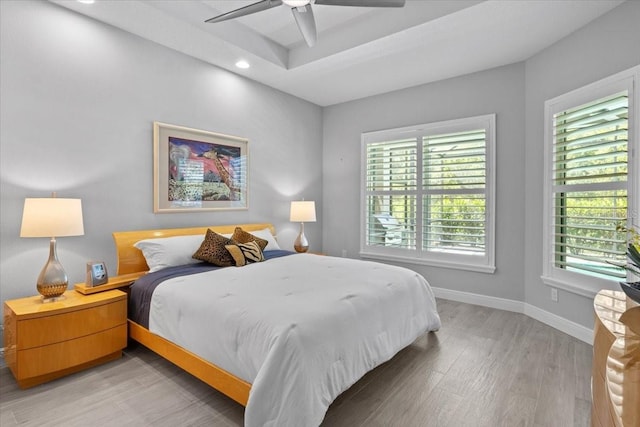 3605 Wild Blossom Pl, Parrish, FL 34219 - bedroom with light wood-style flooring, recessed lighting, ceiling fan, and a tray ceiling