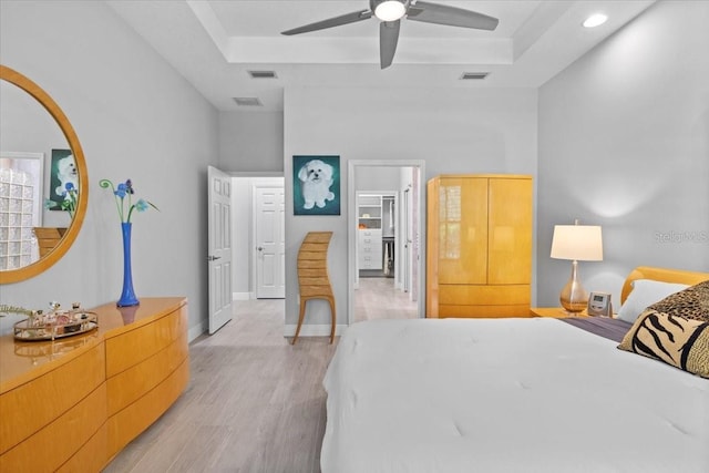 3605 Wild Blossom Pl, Parrish, FL 34219 - bedroom with a raised ceiling, light wood-style floors, a ceiling fan, and recessed lighting