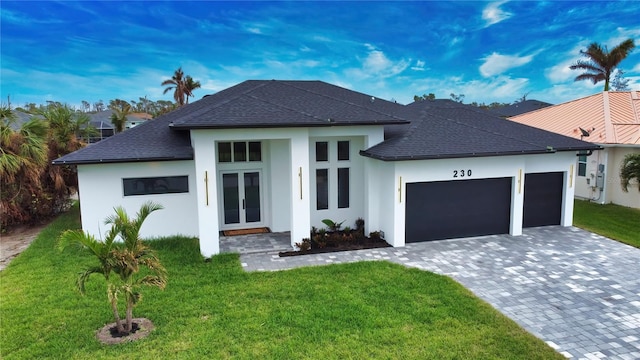 266 W Pine Valley Ln, Rotonda West, FL 33947 - view of front facade featuring french doors, an attached garage, a front yard, decorative driveway, and a shingled roof