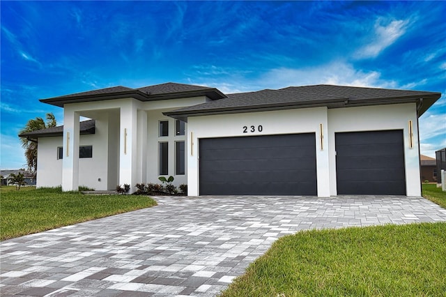 266 W Pine Valley Ln, Rotonda West, FL 33947 - prairie-style house featuring decorative driveway, stucco siding, a garage, and a front lawn
