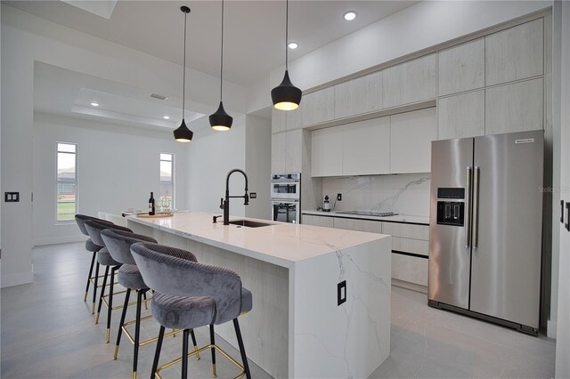 266 W Pine Valley Ln, Rotonda West, FL 33947 - kitchen with stainless steel appliances, modern cabinets, recessed lighting, a kitchen island with sink, and a breakfast bar area
