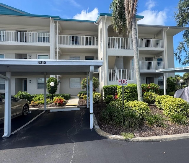 7301 29th Avenue Dr W Unit 310, Bradenton, FL 34209 - view of apartment building / complex featuring covered parking