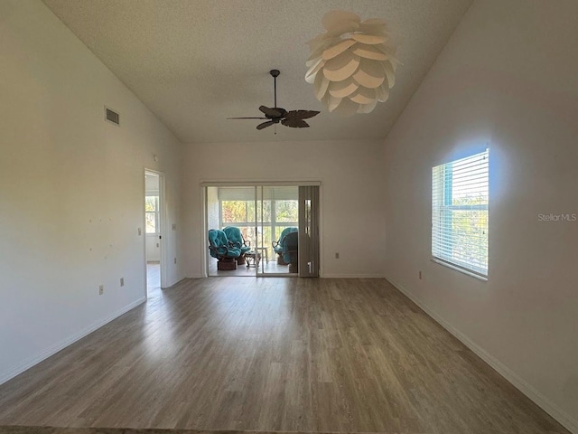 7301 29th Avenue Dr W Unit 310, Bradenton, FL 34209 - empty room with wood finished floors, ceiling fan, high vaulted ceiling, and a textured ceiling