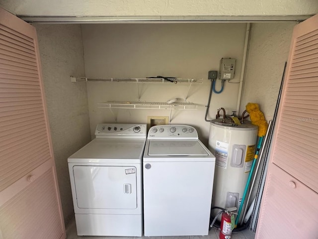 7301 29th Avenue Dr W Unit 310, Bradenton, FL 34209 - washroom featuring electric water heater, washing machine and dryer, and a textured wall