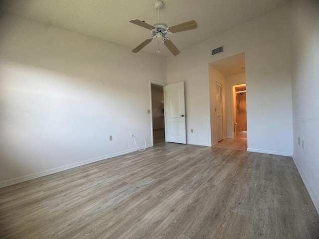 7301 29th Avenue Dr W Unit 310, Bradenton, FL 34209 - unfurnished bedroom with wood finished floors, a ceiling fan, and a spacious closet