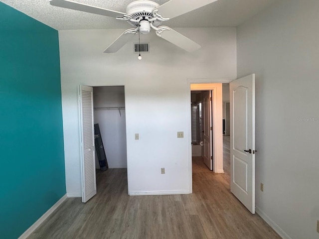 7301 29th Avenue Dr W Unit 310, Bradenton, FL 34209 - unfurnished bedroom with wood finished floors, a closet, and a ceiling fan