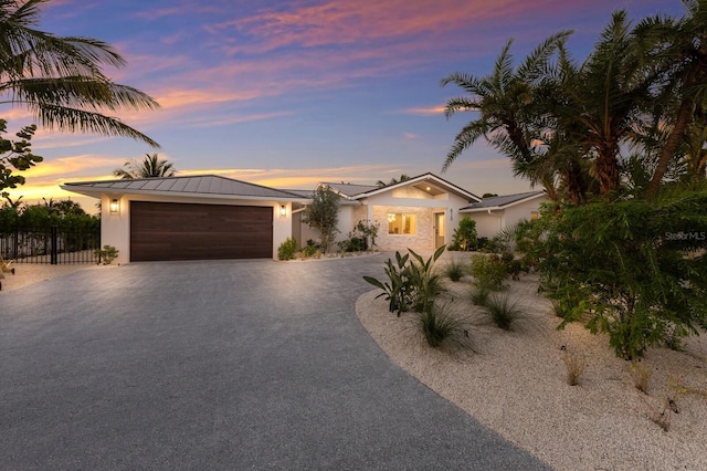 615 Concord Ln, Holmes Beach, FL 34217 - view of front facade with driveway, an attached garage, and stucco siding