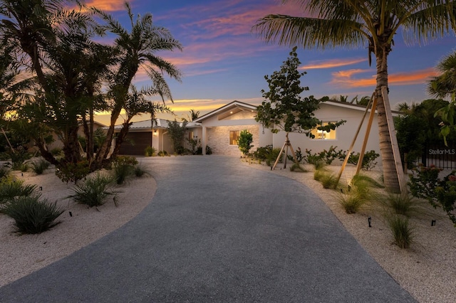 615 Concord Ln, Holmes Beach, FL 34217 - view of front of house with stucco siding and curved driveway