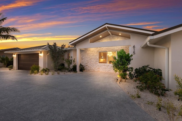 615 Concord Ln, Holmes Beach, FL 34217 - view of front of house featuring stucco siding, driveway, and a garage