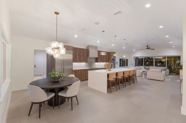 615 Concord Ln, Holmes Beach, FL 34217 - dining space with vaulted ceiling, recessed lighting, a ceiling fan, and a chandelier