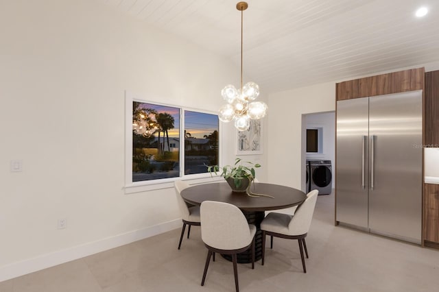 615 Concord Ln, Holmes Beach, FL 34217 - dining area with washer / clothes dryer and a chandelier