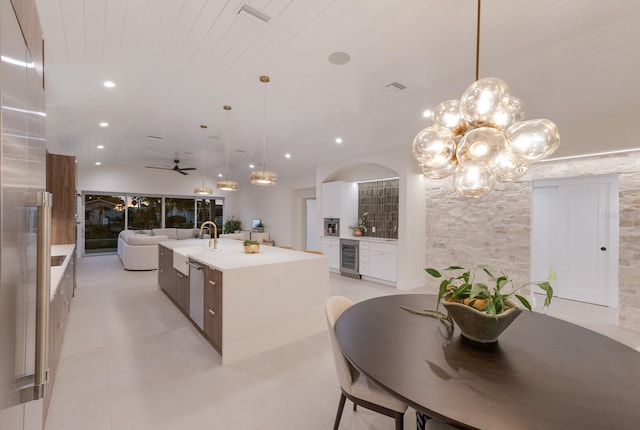 615 Concord Ln, Holmes Beach, FL 34217 - kitchen featuring beverage cooler, stainless steel dishwasher, a center island with sink, modern cabinets, and light countertops