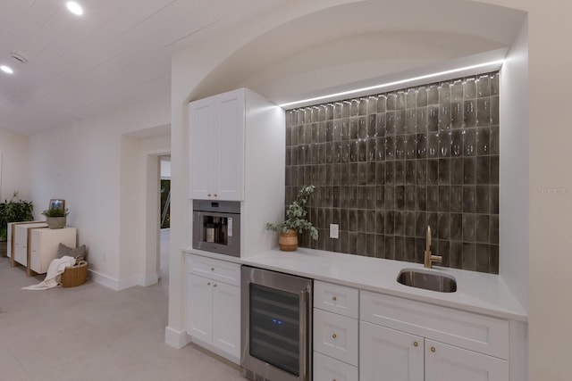 615 Concord Ln, Holmes Beach, FL 34217 - bar with wine cooler, stainless steel oven, and decorative backsplash