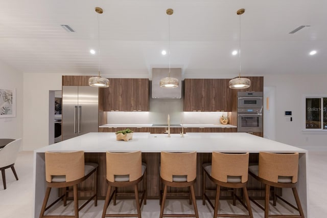 615 Concord Ln, Holmes Beach, FL 34217 - kitchen with modern cabinets, appliances with stainless steel finishes, a spacious island, light countertops, and decorative light fixtures
