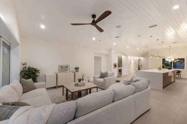 615 Concord Ln, Holmes Beach, FL 34217 - living area with arched walkways, recessed lighting, ceiling fan, a chandelier, and wine cooler