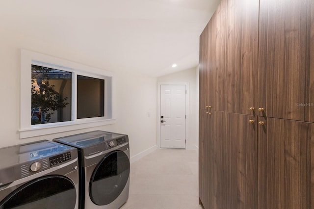 615 Concord Ln, Holmes Beach, FL 34217 - laundry area featuring cabinet space and washer and clothes dryer