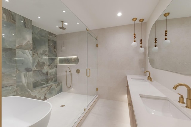 615 Concord Ln, Holmes Beach, FL 34217 - full bath with a stall shower, double vanity, recessed lighting, and a freestanding tub
