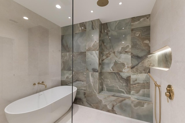 615 Concord Ln, Holmes Beach, FL 34217 - full bath with tile walls, recessed lighting, a freestanding tub, and a walk in shower