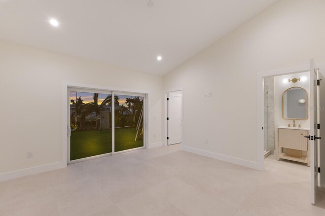 615 Concord Ln, Holmes Beach, FL 34217 - spare room with vaulted ceiling, recessed lighting, and light tile patterned floors