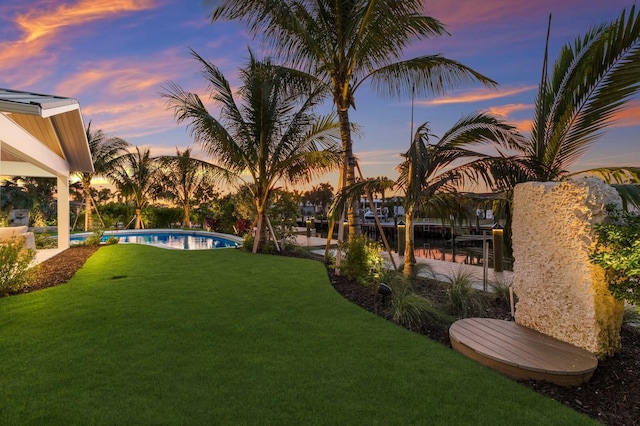 615 Concord Ln, Holmes Beach, FL 34217 - view of grassy yard with an outdoor pool