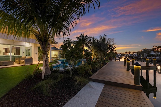 615 Concord Ln, Holmes Beach, FL 34217 - dock area with an outdoor living space, an outdoor pool, and a patio
