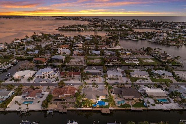 615 Concord Ln, Holmes Beach, FL 34217 - aerial view of property's location featuring a large body of water and nearby suburban area