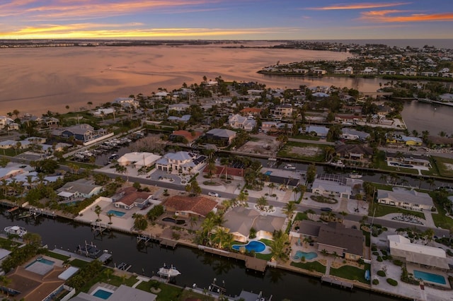 615 Concord Ln, Holmes Beach, FL 34217 - aerial view at dusk of a water view and a residential view