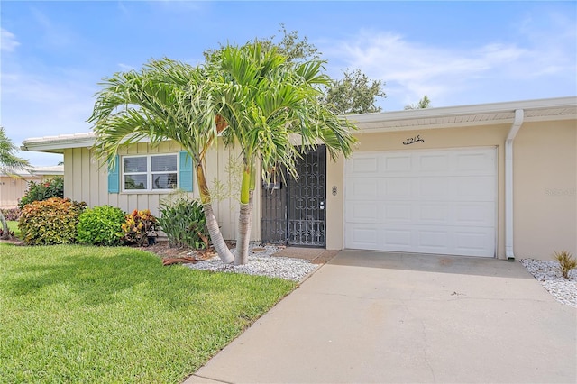 7216 11th Ave W Unit 203, Bradenton, FL 34209 - ranch-style home featuring driveway, a garage, a front lawn, board and batten siding, and stucco siding