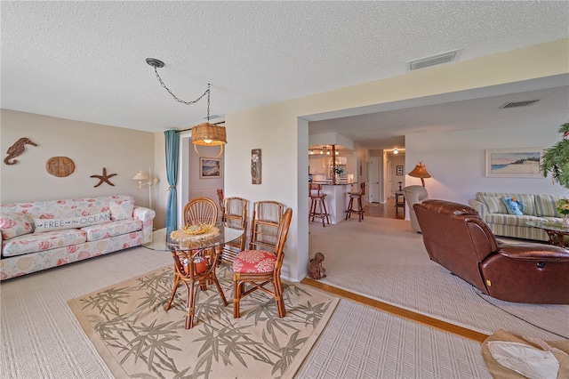 7216 11th Ave W Unit 203, Bradenton, FL 34209 - dining space with carpet floors and a textured ceiling