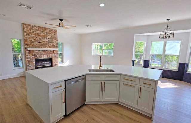 4074 Redbird Cir, Sarasota, FL 34231 - kitchen featuring stainless steel dishwasher, open floor plan, light countertops, light wood-style floors, and recessed lighting