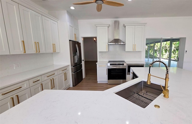4074 Redbird Cir, Sarasota, FL 34231 - kitchen featuring appliances with stainless steel finishes, wall chimney range hood, tasteful backsplash, recessed lighting, and white cabinets