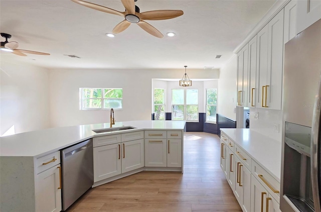 4074 Redbird Cir, Sarasota, FL 34231 - kitchen featuring stainless steel appliances, ceiling fan, healthy amount of natural light, light countertops, and recessed lighting