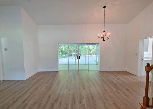 4074 Redbird Cir, Sarasota, FL 34231 - empty room featuring a chandelier and light wood-style flooring