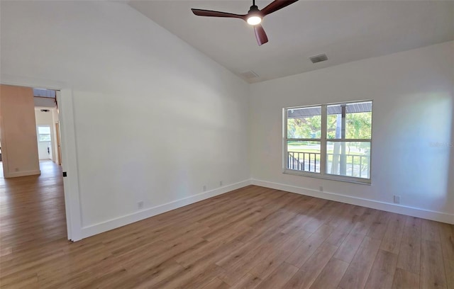 4074 Redbird Cir, Sarasota, FL 34231 - empty room featuring light wood-type flooring, ceiling fan, and high vaulted ceiling