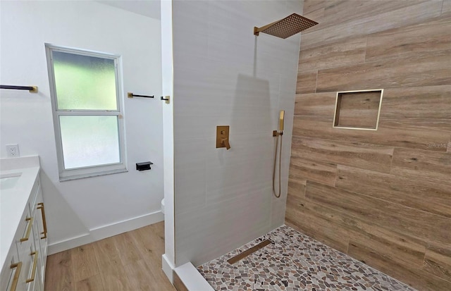 4074 Redbird Cir, Sarasota, FL 34231 - bathroom featuring tiled shower, vanity, and wood finished floors