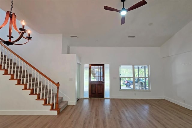 4074 Redbird Cir, Sarasota, FL 34231 - entryway with stairway, wood finished floors, a chandelier, and a ceiling fan