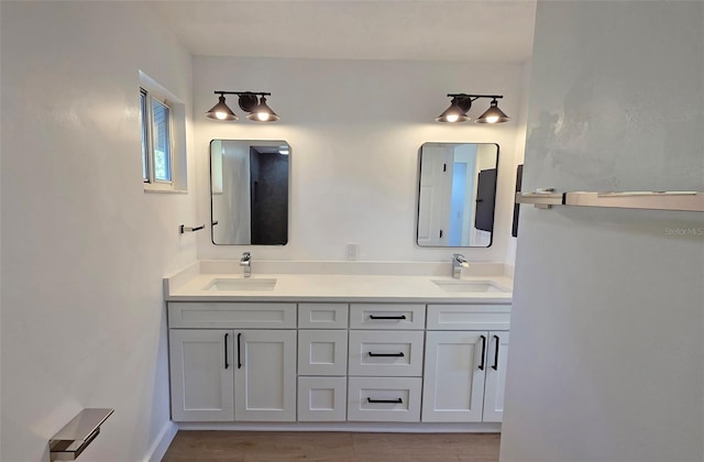 4074 Redbird Cir, Sarasota, FL 34231 - full bathroom featuring double vanity and wood finished floors